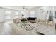 Bright living room showcasing new vinyl plank floors, an elegant chandelier, and a decorative mirror at 1750 Quiet Haven Cir, Indianapolis, IN 46229