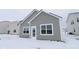 Exterior shot of the rear of a well-kept house with snow covered lawn and a door leading to the outside at 1841 James Pierce Dr, Shelbyville, IN 46176
