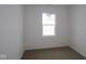 Bright bedroom with neutral carpet and a window providing natural light at 1841 James Pierce Dr, Shelbyville, IN 46176