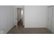 Clean, carpeted bedroom featuring an open doorway and neutral color palette at 1841 James Pierce Dr, Shelbyville, IN 46176