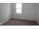 Minimalist bedroom with neutral carpet, a window, and white walls at 1841 James Pierce Dr, Shelbyville, IN 46176