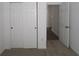 Carpeted bedroom with sliding door closet and an open doorway at 1841 James Pierce Dr, Shelbyville, IN 46176