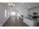 Bright, open-concept living space with hardwood floors, modern fireplace, and a kitchen island with gray countertop at 1841 James Pierce Dr, Shelbyville, IN 46176