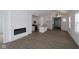Open-concept living space with a fireplace, modern light fixture, and hardwood floors seamlessly connecting to the kitchen at 1841 James Pierce Dr, Shelbyville, IN 46176