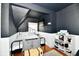 Bedroom features include a dark ceiling, natural lighting, a wrought iron bed frame, and wood flooring at 19 Orchard Ln, Anderson, IN 46011