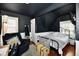 Cozy bedroom with a dark ceiling, area rug, comfortable seating, and wrought iron bed frame at 19 Orchard Ln, Anderson, IN 46011