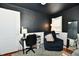 View of a cozy bedroom with a dark ceiling, area rug, comfortable seating, desk, and a mirror at 19 Orchard Ln, Anderson, IN 46011