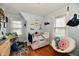 Bedroom featuring a crib, a chair with a donut pillow, and two windows at 19 Orchard Ln, Anderson, IN 46011