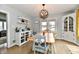 Cozy dining room features wood floors, a modern light fixture, and unique accent furniture at 19 Orchard Ln, Anderson, IN 46011