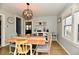 Sunlit dining room with wood floors and neutral walls has a rustic charm at 19 Orchard Ln, Anderson, IN 46011