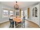 Charming dining room featuring hardwood floors, a rustic table, and lots of natural light at 19 Orchard Ln, Anderson, IN 46011