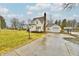Charming yellow two-story home with an attached garage and a concrete driveway at 19 Orchard Ln, Anderson, IN 46011