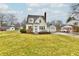 Charming yellow two-story home with an attached garage and a large front yard at 19 Orchard Ln, Anderson, IN 46011