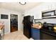 Functional kitchen with tile flooring, black appliances, and wood countertops at 19 Orchard Ln, Anderson, IN 46011