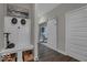 Hallway area with coat rack, bench, decor, and view to living space with wood flooring at 19499 Mcbee Ave, Westfield, IN 46074
