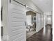 Hallway with sliding barn doors to a cozy sitting room at 19499 Mcbee Ave, Westfield, IN 46074