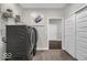 Spacious laundry room view with sliding closet door, front load washer and dryer, and decor at 19499 Mcbee Ave, Westfield, IN 46074