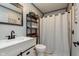 Modern bathroom with vanity, framed mirror, toilet, and shower with curtain at 218 E Carlisle St, Mooresville, IN 46158