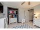 Bedroom featuring a closet, and dresser with a television, plus white storage cabinets at 218 E Carlisle St, Mooresville, IN 46158