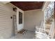 A charming and intimate front porch showcases seating, welcome sign, and warm light fixture at 218 E Carlisle St, Mooresville, IN 46158
