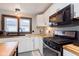 Bright kitchen with stainless steel appliances, butcher block countertops and stylish lighting at 218 E Carlisle St, Mooresville, IN 46158