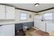 Functional laundry room with washer, dryer, freezer, and ample storage at 218 E Carlisle St, Mooresville, IN 46158