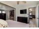 Bright bedroom with closet, dark dresser and a safe, leading into a living room area at 218 E Carlisle St, Mooresville, IN 46158