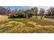 Fenced in backyard with trees and a grassy lawn on a sunny day at 220 Pine Dr, Indianapolis, IN 46260