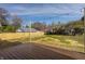 A large backyard with a brown wood deck and decorative string lights at 220 Pine Dr, Indianapolis, IN 46260