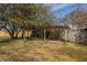A backyard with a wooden pergola in front of a wooden fence and green trees at 220 Pine Dr, Indianapolis, IN 46260