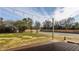 View of large backyard with a wooden deck and string lights under a blue sky at 220 Pine Dr, Indianapolis, IN 46260
