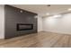 Cozy basement with an electric fireplace and luxury vinyl plank flooring at 220 Pine Dr, Indianapolis, IN 46260