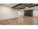 Finished basement with modern fireplace and neutral-toned luxury vinyl plank flooring at 220 Pine Dr, Indianapolis, IN 46260