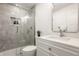Modern bathroom features a glass-enclosed shower, sleek vanity with white countertop and chrome fixtures at 220 Pine Dr, Indianapolis, IN 46260