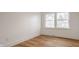 Light filled bedroom with hardwood floors and white trim at 220 Pine Dr, Indianapolis, IN 46260
