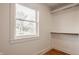 A simple yet organized closet with shelving and a clothes rack and window provides natural light at 220 Pine Dr, Indianapolis, IN 46260