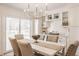 Cozy dining area features modern chandelier, stylish furniture and neutral decor for elegant meal times at 220 Pine Dr, Indianapolis, IN 46260