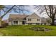 Charming home featuring a well-manicured lawn and a mix of brick and siding exterior elements at 220 Pine Dr, Indianapolis, IN 46260