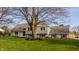 Lovely home exterior with mature trees, offering a blend of brick and siding for classic curb appeal at 220 Pine Dr, Indianapolis, IN 46260