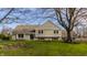 Inviting home exterior showcasing lush green lawn, mature trees, and well-maintained landscaping at 220 Pine Dr, Indianapolis, IN 46260