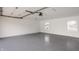 A two car garage with epoxy flooring and white painted walls at 220 Pine Dr, Indianapolis, IN 46260