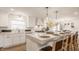 Bright, fully equipped kitchen with quartz countertops, modern appliances, and bar seating at 220 Pine Dr, Indianapolis, IN 46260