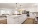 Open-concept kitchen with large island, stainless steel appliances, and seamless flow to the living room at 220 Pine Dr, Indianapolis, IN 46260