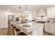 Spacious, modern kitchen features stainless steel appliances, white cabinets, and pendant lighting at 220 Pine Dr, Indianapolis, IN 46260