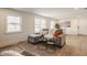 Bright, open living room with large windows, hardwood floors, and comfortable seating at 220 Pine Dr, Indianapolis, IN 46260