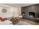 Cozy living room has painted fireplace, natural light and warm decor to create an inviting space at 220 Pine Dr, Indianapolis, IN 46260