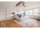 Spacious main bedroom featuring large windows, hardwood floors, and modern ceiling fan at 220 Pine Dr, Indianapolis, IN 46260