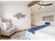 Bright main bedroom with a cozy chair, vaulted ceilings, and modern decor at 220 Pine Dr, Indianapolis, IN 46260