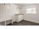 Mudroom includes a white storage cabinet, a wooden countertop, a bench, coat rack, and a window at 220 Pine Dr, Indianapolis, IN 46260