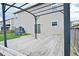 Large wooden deck with a metal pergola, adjacent to lawn, and a view of the home's exterior at 2336 Boneset Dr, Plainfield, IN 46168